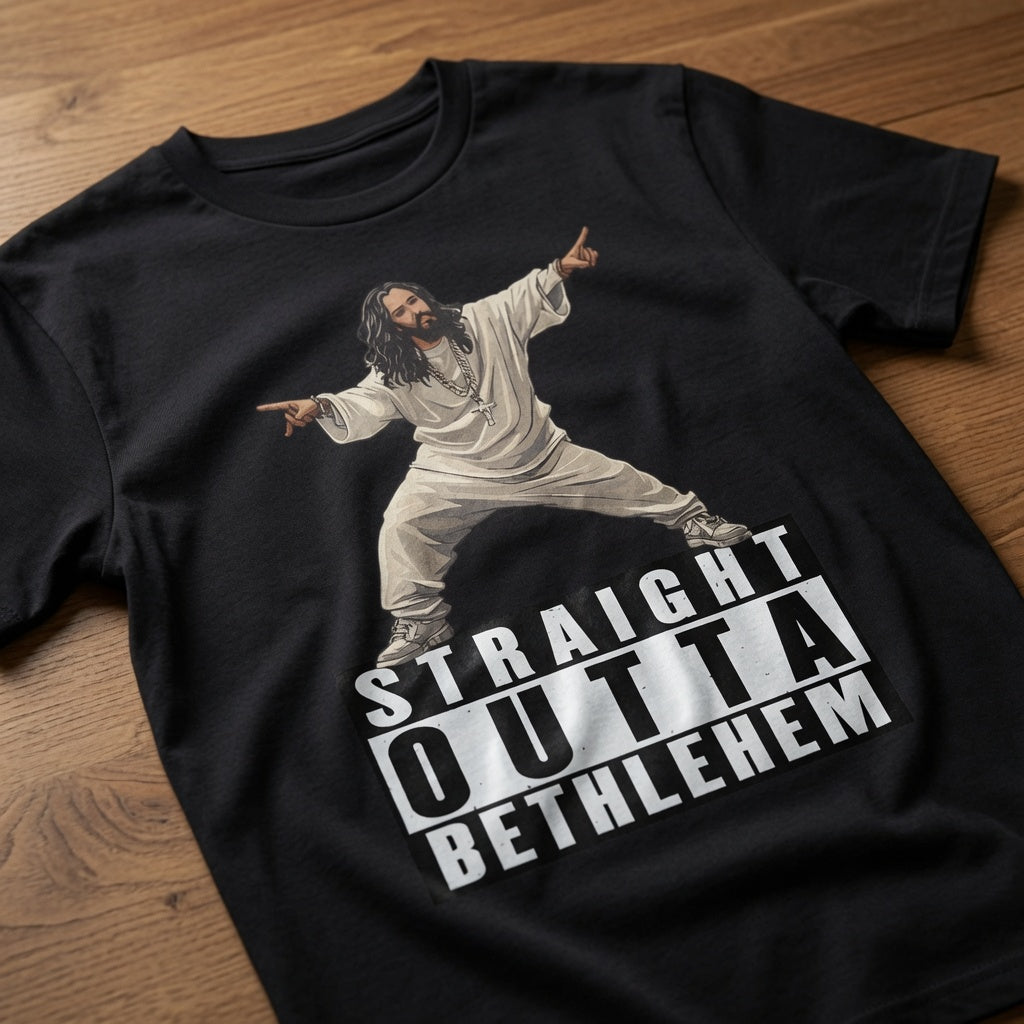Black Straight Outta Bethlehem t-shirt laid flat on a wooden surface showing the full Jesus rapper graphic, funny mens offensive witty jesus rapper design full of pure attitude