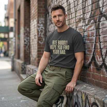 Man in dark grey Bye Buddy Hope You Find Your Dad t-shirt against brick wall, funn xmas movie slogan tee