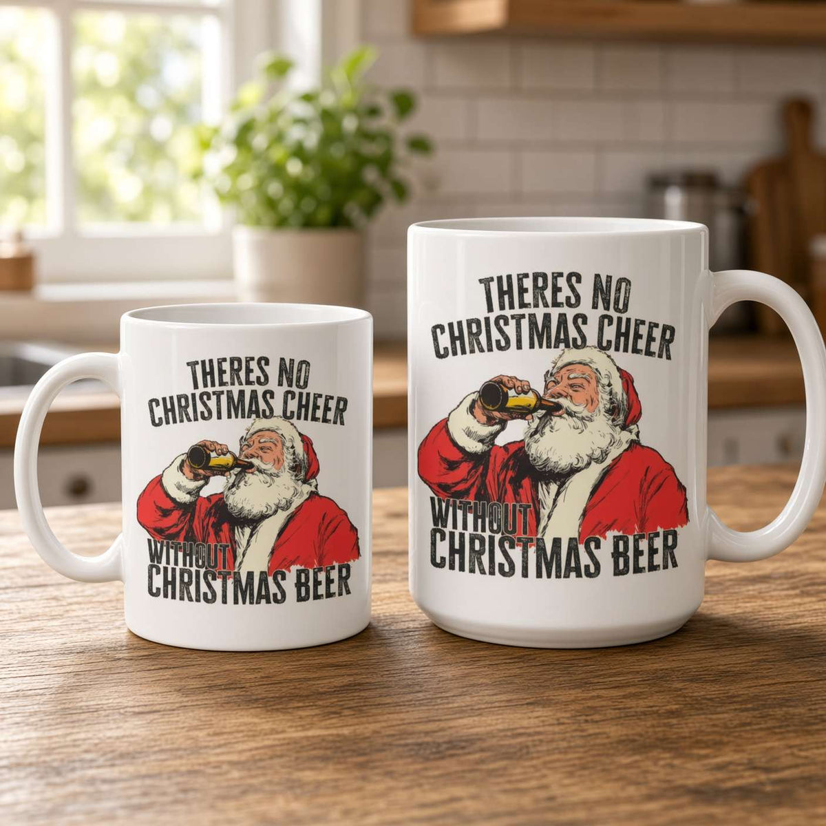 Two white ceramic mugs on a wooden kitchen counter feature a red-suited Santa drinking beer and the slogan, “There’s no Christmas cheer without Christmas beer,” in a cozy, playful setting.
