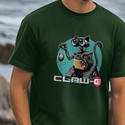 A man wearing a dark green funny Cat T-shirt featuring a robot with cat ears. The robot holds a small mouse toy, with text 