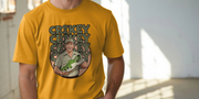 Man in mustard funny graphic t-shirt with cartoon of a smiling Steve Irwin holding a crocodile. Text 