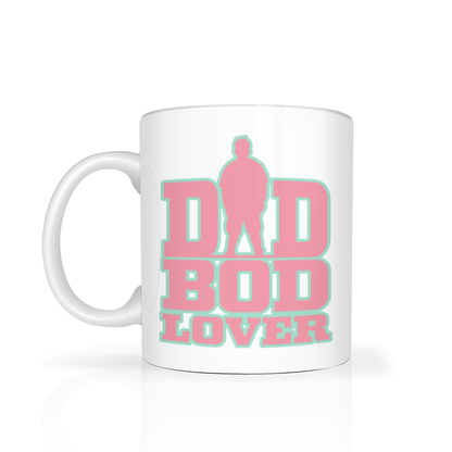 A white ceramic mug with a pink and mint green graphic that reads 'DAD BOD LOVER' with a silhouette figure integrated into the design, shown on a clean white background.