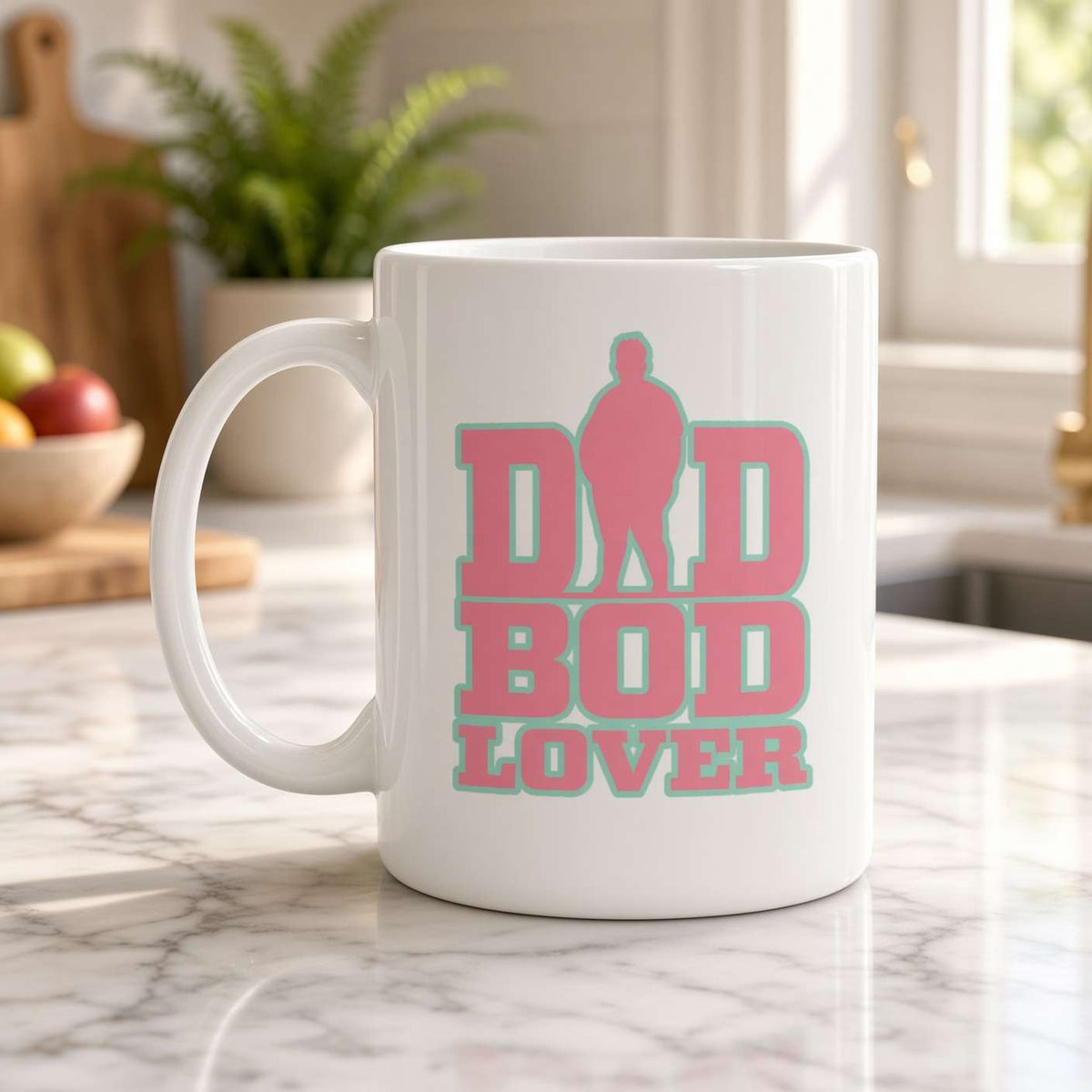 A white ceramic coffee mug with a pink and teal graphic reading 'DID BOD LOVER' sits on a marble kitchen countertop with a blurred kitchen background.