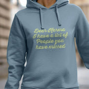 Woman wearing a blue Women's hoodie with the text, 