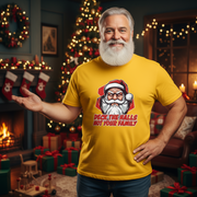 Man wearing a yellow funny Christmas t-shirt with a Santa Christmas-themed design in a festive room.