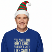 Man wearing a blue Christmas sweater with humorous Elf text 