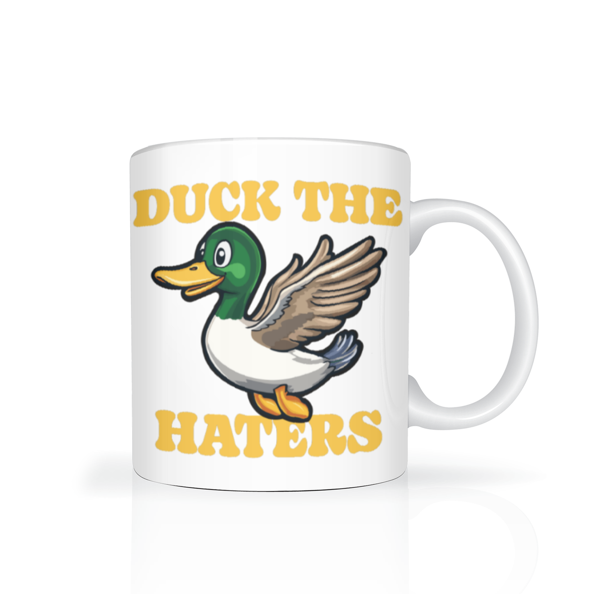 A white ceramic mug features a cheerful cartoon duck with raised wings and the yellow slogan “DUCK THE HATERS,” creating a playful, upbeat feel.