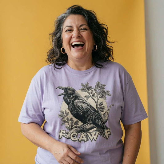 Woman laughing while wearing a lavender FCAWF t-shirt, funny ladies offensive raven pun viral design full of pure attitude