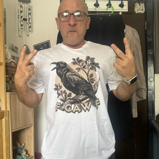 Customer photograph featuring a Bald man wearing glasses and a white Fcawf T-shirt with a crow design and funny slogan "Fcawf", standing indoors showing peace signs. The tone is funny, casual and confident.
