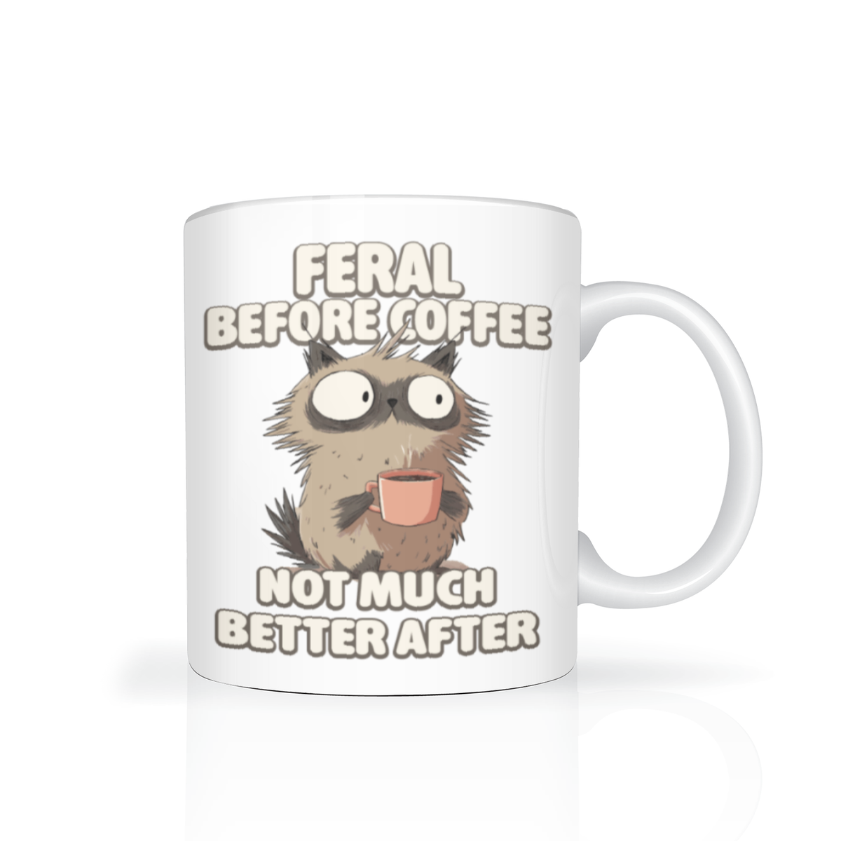 White mug featuring a wide-eyed, shaggy ca holding a tiny cup, with the joke “Feral before coffee, not much better after”—playful, sleepy humor.