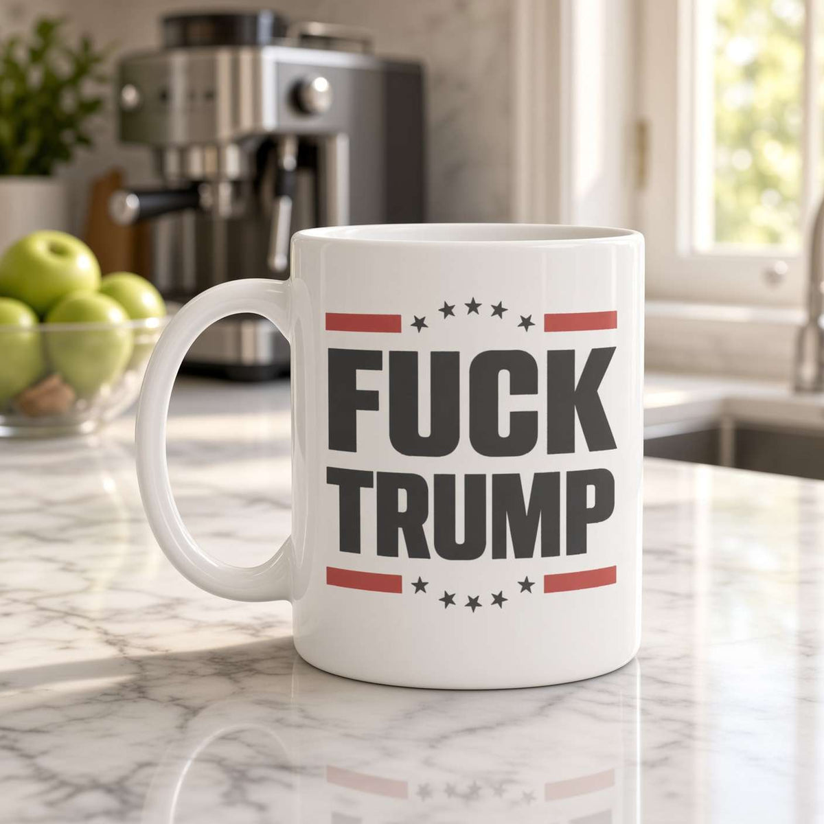White “FUCK TRUMP” mug with red stripes and black stars on a marble kitchen counter near a coffee machine and green apples; a defiant political message.