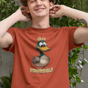 Smiling man wearing an orange funny animal t-shirt with a cartoon duck and text 