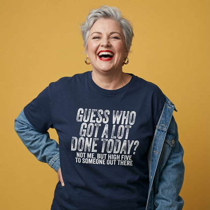 Woman laughing with one hand on her hip and a denim jacket over her shoulders while wearing a navy Guess Who Got A Lot Done Today t-shirt, funny ladies witty statement design full of pure attitude