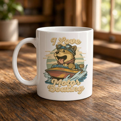 White ceramic mug on a sunlit wooden table, printed with a cheerful goggle-wearing dog steering a motorboat and the words “I Love Motor Boating.”