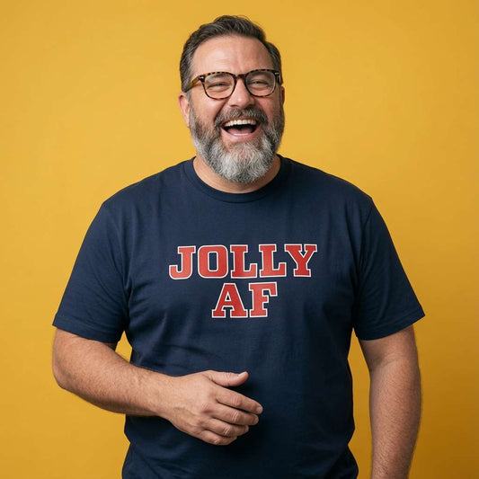 Man laughing with one hand near his stomach in a navy Jolly AF t-shirt, funny mens Christmas day banter statement design full of pure attitude