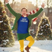 Elf in festive outfit with 'Santa? I Know Him!' shirt in a snowy Christmas setting