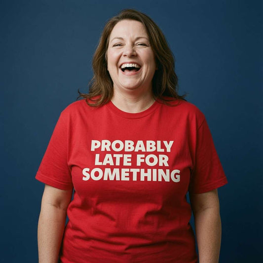Woman laughing with both arms by her sides in a red Probably Late For Something t-shirt, funny ladies cheeky relatable statement design full of pure attitude
