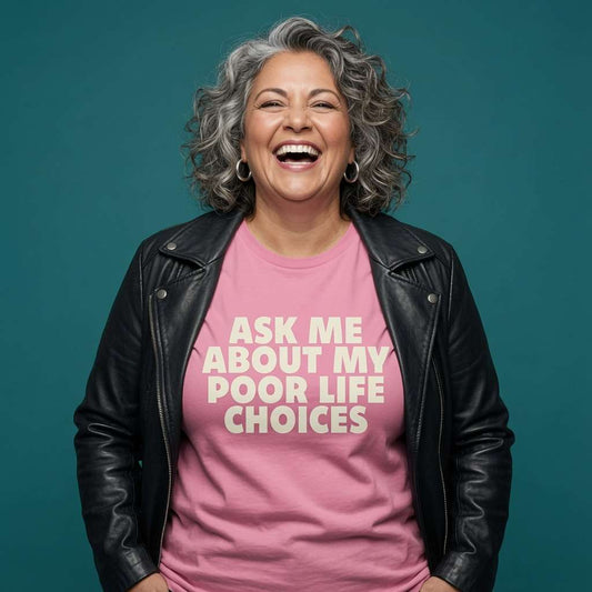 Woman laughing with a black leather jacket over her shoulders while wearing a pink Ask Me About My Poor Life Choices t-shirt, funny witty relatable ladies statement design full of pure attitude