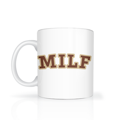 A white ceramic coffee mug with the word 'MILF' printed on the side in brown varsity-style letters with a gold outline, set against a clean white background with a soft reflection.