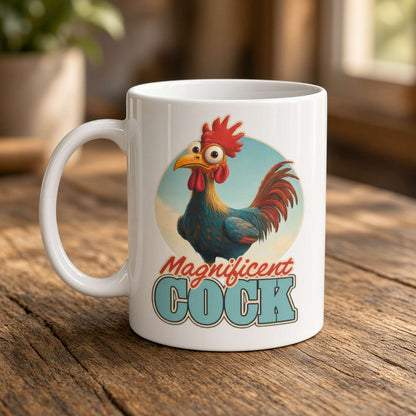 White ceramic mug on a rustic wooden table, featuring a colorful cartoon rooster and the words “Magnificent Cock”; playful, humorous tone.