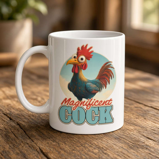 White ceramic mug on a rustic wooden table, featuring a colorful cartoon rooster and the words “Magnificent Cock”; playful, humorous tone.