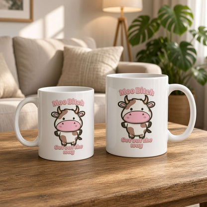 Two white mugs on a wooden coffee table feature playful cartoon cows and the phrase “Moo Bitch, get out the way.” A cozy, sunlit living room feels warm and relaxed.