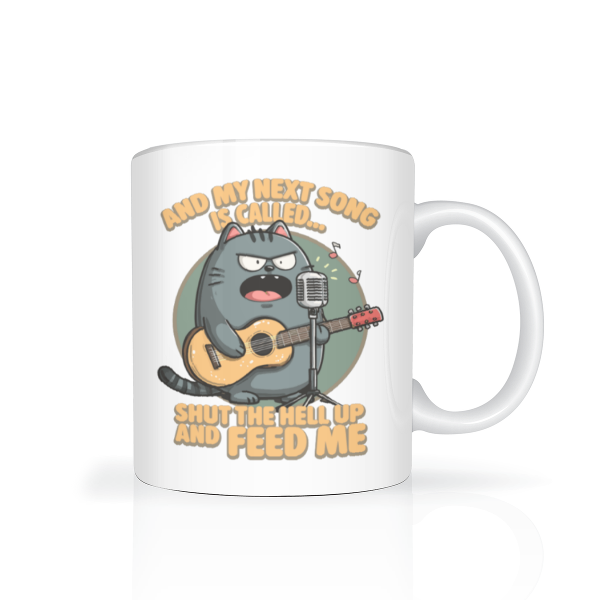 White coffee mug featuring a grumpy cartoon gray cat playing guitar at a microphone, with musical notes and the joke, “Shut the hell up and feed me.” The tone is playful and sarcastic.