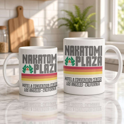 Two white Narcatomi Plaza mugs of different sizes sit on a sunlit marble counter, with retro hotel lettering and colorful stripes; a calm, warm kitchen scene.