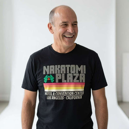 Bald man laughing in black Nakatomi Plaza tee, mens retro film inspired xmas
