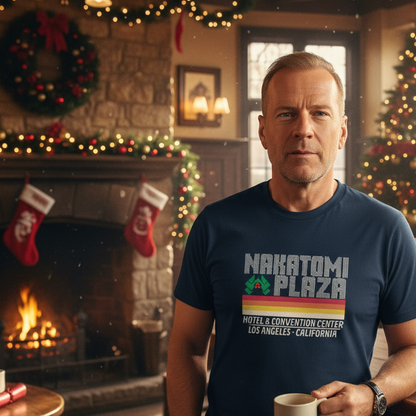Man wearing a 'Nakatomi Plaza' t-shirt in a festive room with Christmas decorations.
