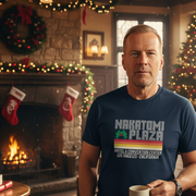 Man wearing a 'Nakatomi Plaza' t-shirt in a festive room with Christmas decorations.