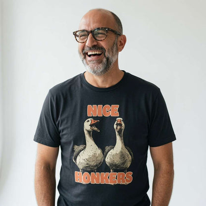 Bald man with glasses laughing heartily in a black Nice Honkers t-shirt, funny cheeky goose graphic that delivers pure rude banter