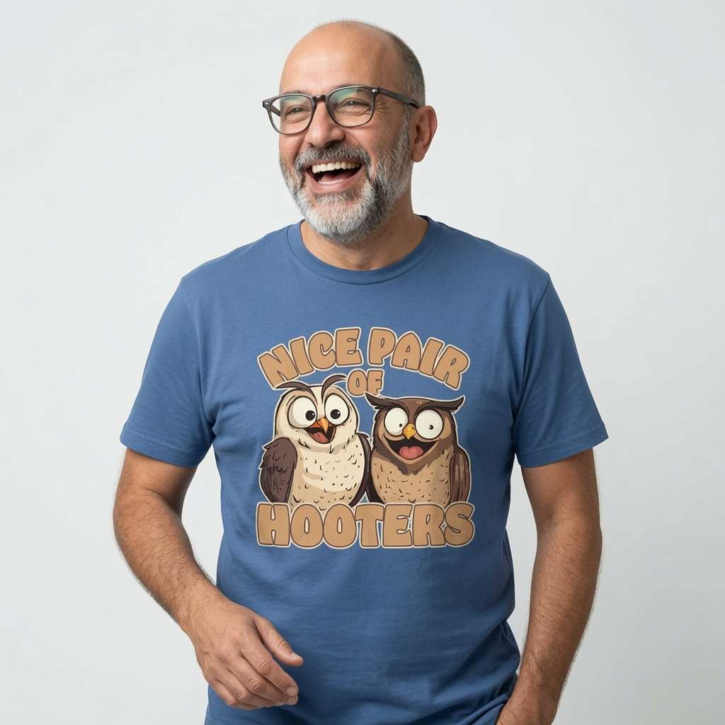 Bald man with glasses laughing heartily in a blue Nice Pair of Hooters t-shirt, witty and cheeky animal pun that never gets old