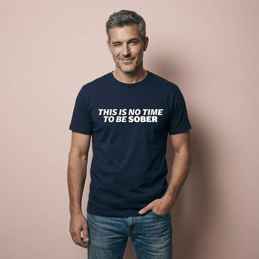 Grey-haired man giving a knowing wink and half-smile while wearing a navy This Is No Time To Be Sober t-shirt, perfect funny alcohol pub banter