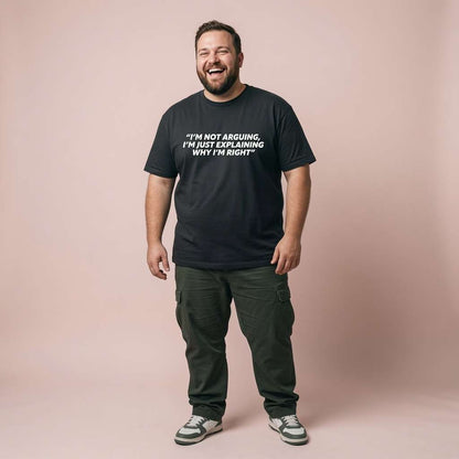 Man laughing heartily while wearing a black I’m Not Arguing, I’m Just Explaining Why I’m Right t-shirt, funny and sarcastic statement every bloke will claim is true