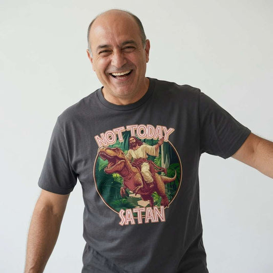 Bald man laughing widely with one arm outstretched in a dark grey Not Today Satan t-shirt, hilarious Jesus raptor graphic full of witty energy