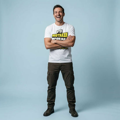 Man laughing with arms crossed while wearing a white Often Mistaken For An Adult Because Of My Age t-shirt, fun and witty Fathers Day gift slogan
