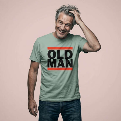 Man laughing with one hand in his hair in an aloe green Old Man t-shirt, funny and witty old slogan that owns the title with pride