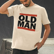 Man wearing a cream Dad T-shirt with bold black 