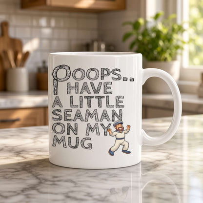 A white ceramic coffee mug with a humorous seaman-themed graphic and text, displayed on a marble kitchen counter with a blurred kitchen background.