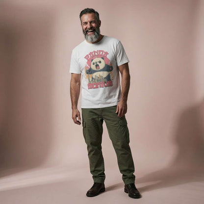 Bearded man laughing while wearing a white Pandamonium t-shirt featuring a roaring giant panda over a city skyline, cheeky and witty funny panda pun design
