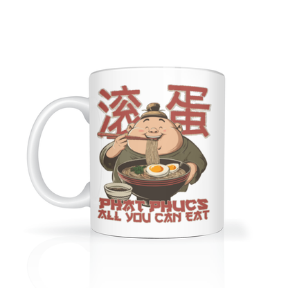 White ceramic mug featuring a smiling cartoon noodle chef eating a bowl of noodles, with red Chinese characters and “PHAT PHUCS ALL YOU CAN EAT” text; playful, humorous design.