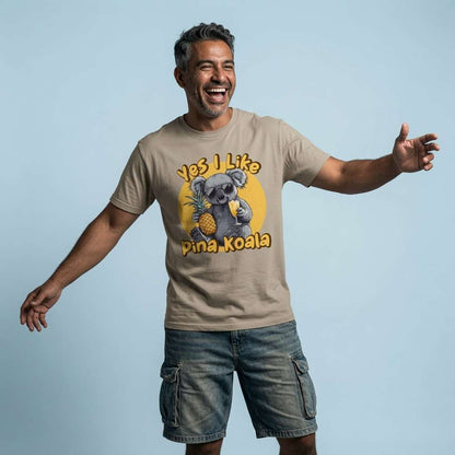 Man laughing with arms outstretched in a beige Yes I Like Pina Koala t-shirt, funny and witty cocktail pun graphic full of pure holiday energy