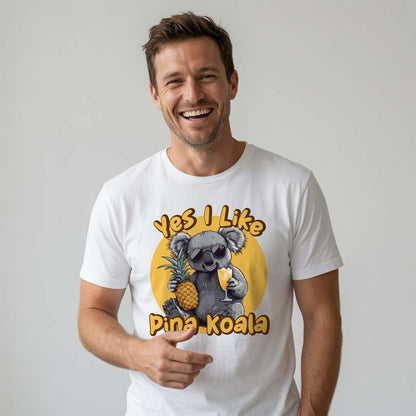 Man smiling while wearing a white Yes I Like Pina Koala t-shirt featuring a cool koala in sunglasses holding a pineapple and cocktail, fun and witty cute kawaii animal graphic