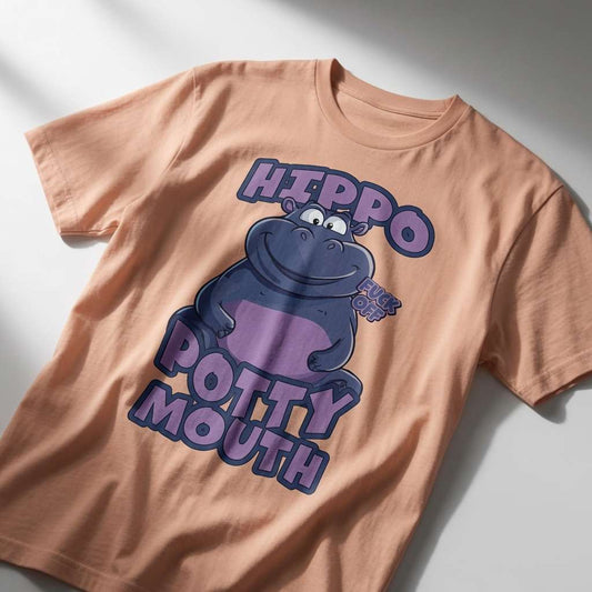 Peach Hippo Potty Mouth t-shirt laid flat featuring a smiling cartoon hippo with a “Fuck Off” speech bubble and the text “Hippo Potty Mouth”, funny and witty offensive animal graphic design