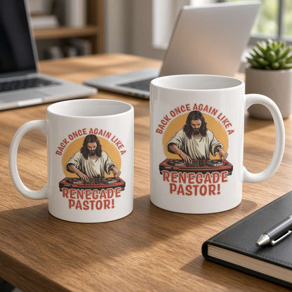 Two white “Renegade Pastor!” mugs with a guitar-playing pastor illustration sit on a wooden desk beside laptops and a notebook, creating a playful office scene.