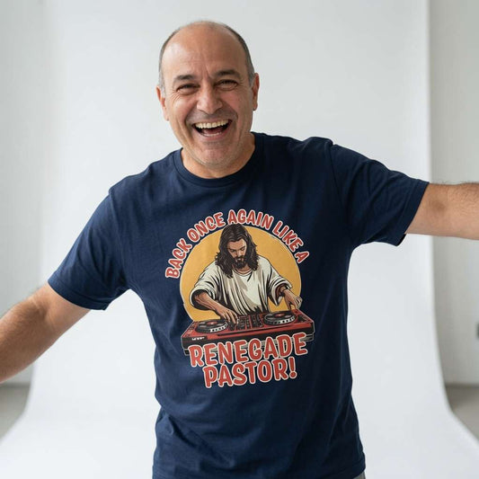 Man laughing with arms outstretched while wearing a navy Back Once Again Like a Renegade Pastor! t-shirt featuring Jesus as a DJ on the decks, fun and witty cheeky Jesus graphic