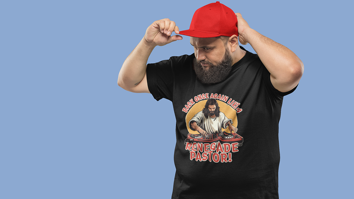 Man wearing a black funny t-shirt with a Jesus graphic design and a red cap on a blue background