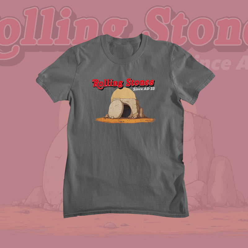 Gray Funny Offensive T-shirt featuring a cartoon illustration of a rock tomb with a rolled-away stone. Text above reads "Rolling Stones Since AD 33" in red and white.