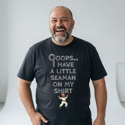Bald bearded man laughing in a black Ooops.. I Have a Little Seaman on My Shirt t-shirt, funny and cheeky mens offensive sailor graphic that every dirty-minded lad will claim